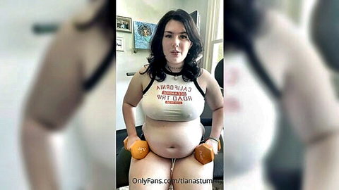Chubby Tiana Sturm in crop top, holding dumbbells for sexy workout