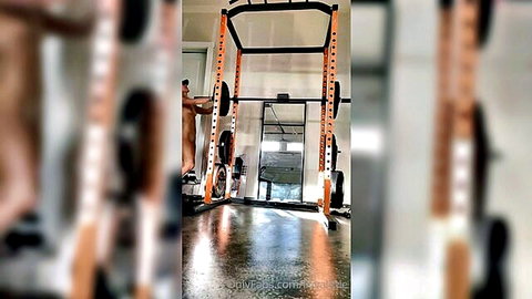 Nude woman bending over in gym, solo workout tease