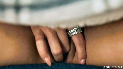 Closeup of woman spreading thighs with ringed fingers teasing pussy