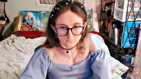 Paige in glasses and blue off-shoulder top, seductive gaze