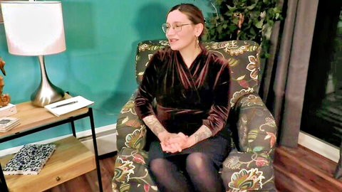 Bettie Bondage as seductive therapist encouraging taboo desires, tattoos and glasses