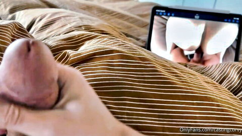 Chunky MILF teases big ass in porn video on tablet while hand holds cock