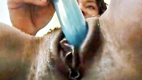 Closeup of wet shaved pussy penetrated by thick blue dildo during masturbation