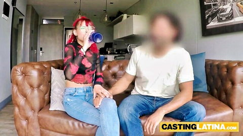 Petite Hispanic teen in sheer red top holds hands with guy on casting couch