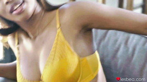 Seductive Latina babe in yellow bra showing cleavage
