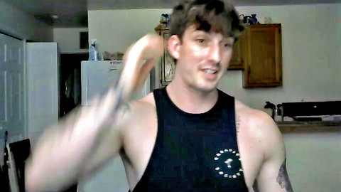 Tattooed muscular guy flexing biceps in black tank top amateur kitchen webcam