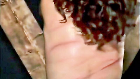 Pale woman's ass cheek striped with red welts from intense caning whipping