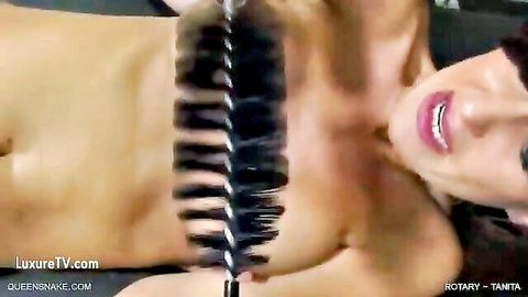 Skinny brunette with small tits lies topless smiling as feather duster teases her nude torso