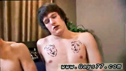 Shirtless tattooed guy with mask chest tats and friend in gay threesome preview