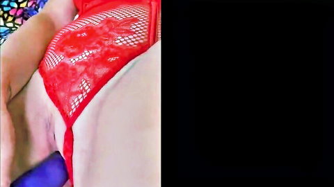 Woman in red lace lingerie with purple dildo inserted, close-up penetration view