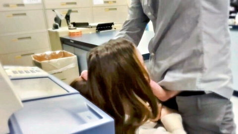 Brunette bent over office desk in steamy workplace hookup