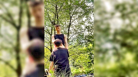 Amateur guys in tank tops grinding doggy style outdoors in forest woods