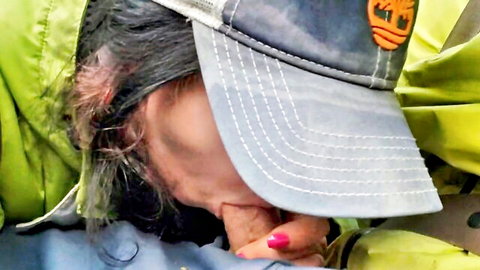 Woman in trucker hat giving road head blowjob with cum spill