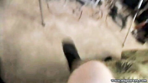 Blurry POV of redhead babe bending over near stripper pole in dark club