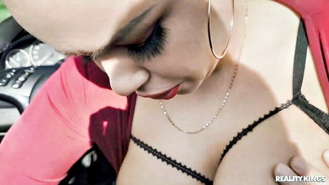 Sofia Lee with shaved head in red top, Ian Scott touching her cleavage