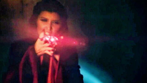 Mysterious brunette in dark robe holds glowing red gem in Thrones XXX parody