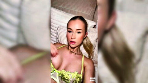 Blonde beauty in sheer green lace lingerie teases seductively, inviting daddy to play