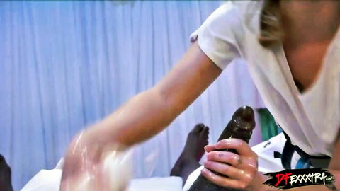 Blonde masseuse strokes big black cock during erotic massage