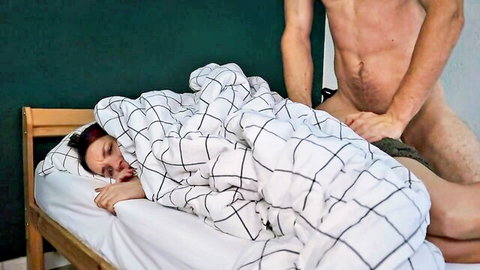 Naked muscular stepfather gropes embarrassed woman in bed under sheets