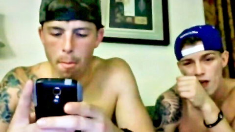 Two sexy tattooed shirtless buddies looking horny together