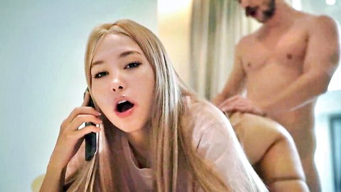 Blonde Asian woman on phone, moaning in doggy style with naked man grabbing her ass