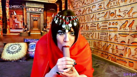 Brunette MILF in exotic red attire sucking dildo passionately