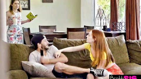 Redhead teen in yellow top and pink skirt teases guy on couch, mom watches