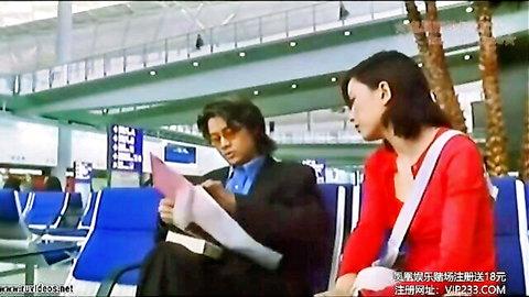 Hong Kong erotic film scene: suited man and woman in tense airport lounge