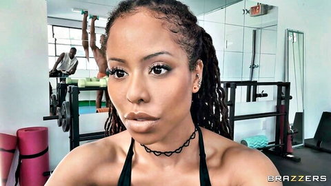 Ebony fitness influencer with dreads eyes gym bros in seductive gym pose