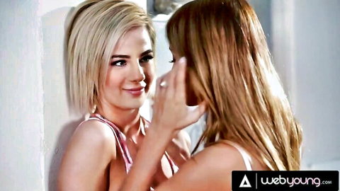 Young blonde and redhead lesbians in lingerie intimately caressing faces close-up