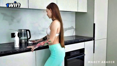 Marcy Abadir in white bra and green shorts cleaning, teasing view