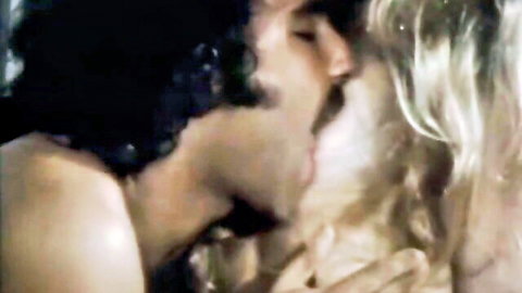 Vintage couple in intimate kiss, curly-haired man and blonde in Aqua Sex classic