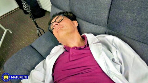 Mature man in lab coat relaxing on sofa, Conny Dachs featured