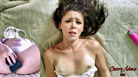 Petite brunette Cherry Adams topless with small tits, hand on panty-covered pussy with vibrator nearby, orgasm face