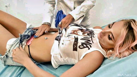 Doctor examines pink-haired girl's exposed pussy with gloved hands in medical fetish scene