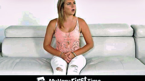 Curvy blonde in pink lace top and ripped jeans sits surprised for first anal video