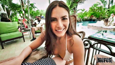 Smiling brunette in white bikini flashes at poolside for risky outdoor sex