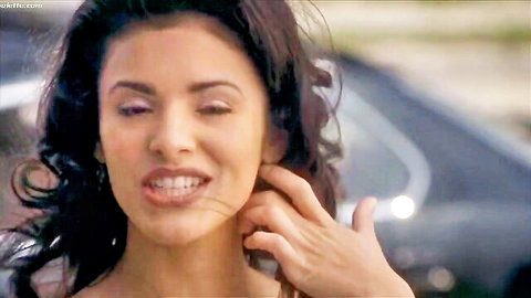 Gladise Jiminez smiling seductively with hand on neck in Blowback (2000)