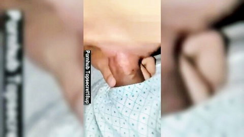Close-up of pink pussy spread wide open by fingers under hospital gown