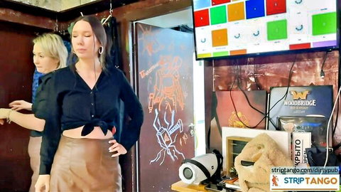 Brunette in tied black shirt & leather skirt with blonde in cam tease duo