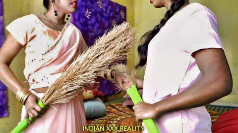 Indian bhabhi in saree and young girl holding brooms in Desi reality scene