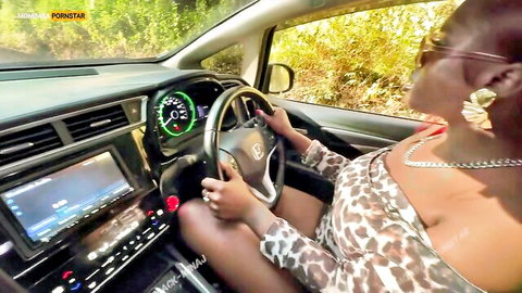 Sexy ebony babe driving car in leopard top showing massive cleavage tits