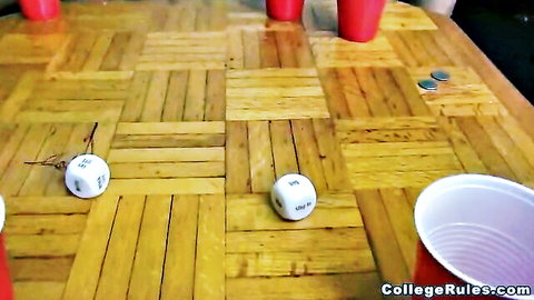 College party table with red solo cups, white dice, coins on wooden surface