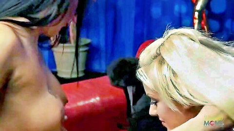 Two topless beauties, one blonde and one brunette, in intimate orgy embrace