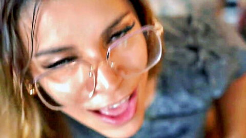 Smiling Asian woman in clear glasses with wet hair, close-up face from lesbian oral porn thumbnail