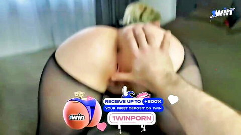 Blonde with big ass bent over in black mesh lingerie, hand grabbing her curves in hardcore neighbor scene