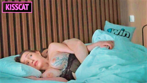 Stepmom exposes tattooed tits in bed as stepson touches her intimately