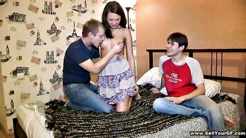Amateur threesome: brunette teen topless in skirt, tits sucked by man while another watches