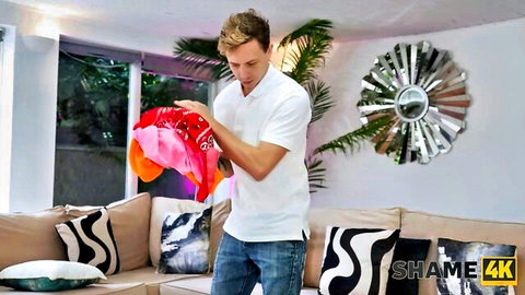 Fit man holding pink and orange lingerie in teasing MILF scene from Shame4K