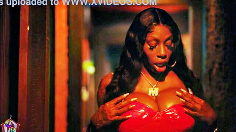 Black Mystique in red latex bra, teasing with big breasts on Valentine's Day